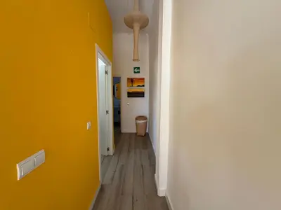 a hallway with a yellow wall and a white door at Petite Penthouse with the sunniest terrace in Valencia in Valencia
