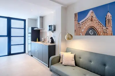 a living room with a couch and a picture of a church at Portal de Ruzafa 1 in Valencia