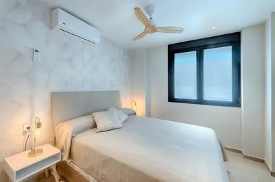 a bedroom with a bed and a ceiling fan at Portal de Ruzafa 1 in Valencia