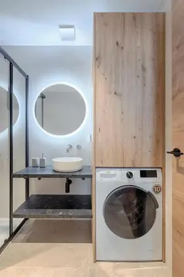 a bathroom with a washing machine and a sink at Portal de Ruzafa 1 in Valencia