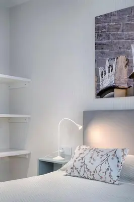 a bedroom with a bed and a brick wall at Ruzafa´s Gate 3 in Valencia