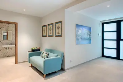 a living room with a blue chair and a window at Portal de Ruzafa 4 in Valencia