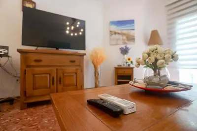 a living room with a tv and a remote control on a table at Lovely apartment near the beach & City of Arts and Sciences in Valencia