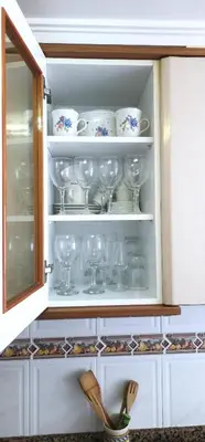 a cupboard filled with glasses and plates and bowls at Vacansis Sant Germein in Cullera