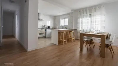 a kitchen and dining room with a table and chairs at Apartamentos Borriana in Burriana