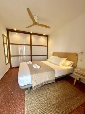 a bedroom with two beds and a ceiling fan at District Key - Saler, Av Gola Puchol 14 in Valencia