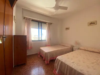 a bedroom with two beds and a window at Maripatri Solo Familias Serviplaya!!! in Casas Las Basas