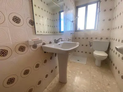 a bathroom with a sink and a toilet and a window at Maripatri Solo Familias Serviplaya!!! in Casas Las Basas
