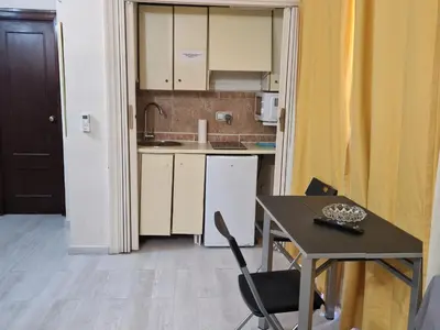 a small kitchen with a table and a table and chairs at Style Apartments City Center in Valencia