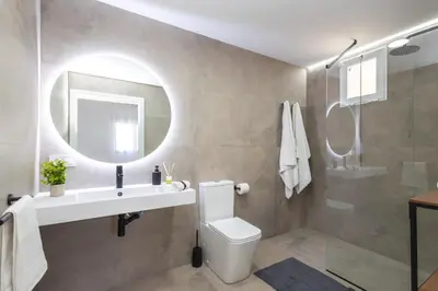 a bathroom with a toilet and a sink and a mirror at Moderno, amplio y muy cómodo in Valencia
