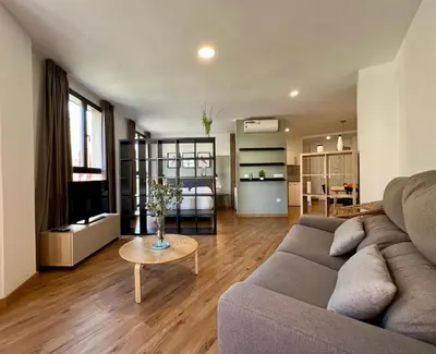 a living room with a couch and a table at Apartamentos de Pradas in Valencia