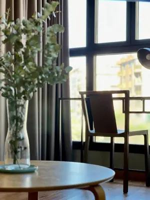 a vase of flowers sitting on a table next to a window at Apartamentos de Pradas in Valencia