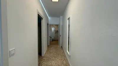 a hallway with white walls and a ceiling at Cabañal Retreat in Valencia