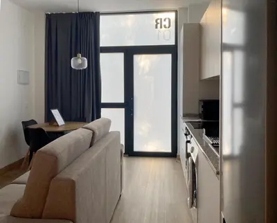 a living room with a couch and a table at Dormavalencia Crónica in Valencia