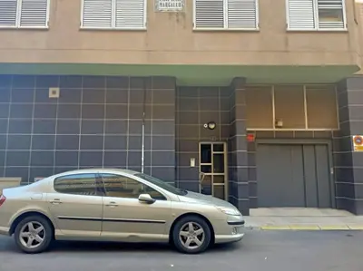 a silver car parked in front of a building at Lindo y Discreto apartamento playa in Moncófar
