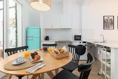 a kitchen with a wooden table with food on it at Travel Habitat Bioparc Apartments in Valencia