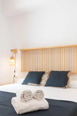 a bedroom with a bed with two towels on it at Travel Habitat Bioparc Apartments in Valencia