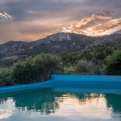 a swimming pool with a mountain in the background at House -Sleeps 8-Natural Pool-Pet Friendly in Artana