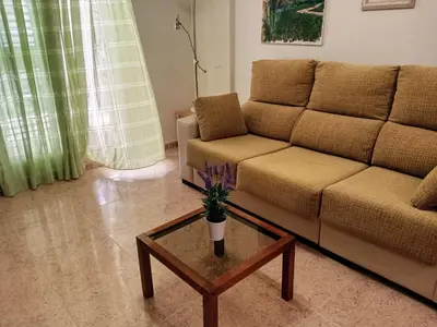 a living room with a couch and a coffee table at Apartamento playa de Canet WIFI in Canet de Berenguer