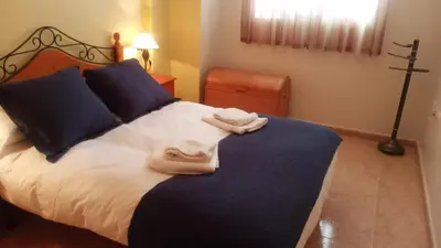 a bedroom with a bed with towels on it at Apartamento playa de Canet WIFI in Canet de Berenguer