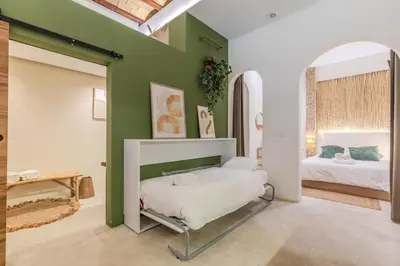 a bedroom with a bed and a green wall at GREEN&FRESH Apartament in Valencia