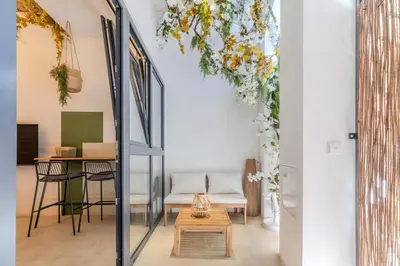 a room with a table and chairs and a ceiling with flowers at GREEN&FRESH Apartament in Valencia