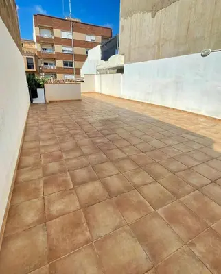 an outdoor patio with a tile floor at UIM Mediterraneo CASA Gomez Ferrer Wifi in Puerto de Sagunto