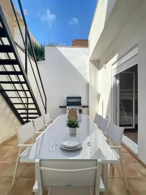 a white dining room with a white table and chairs at UIM Mediterraneo CASA Gomez Ferrer Wifi in Puerto de Sagunto