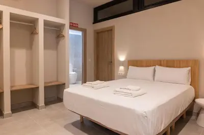 a bedroom with a large white bed with towels on it at VLC HOST - Molina del Palau in Valencia
