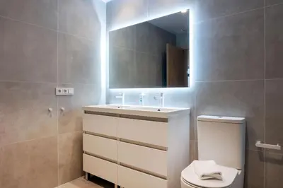a bathroom with a sink and a toilet and a mirror at VLC HOST - Molina del Palau in Valencia