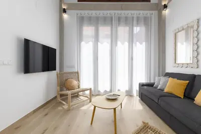 a living room with a couch and a table at ApartUP Ca La Leni Beach IV in Valencia
