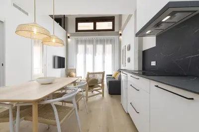 a kitchen and dining room with a table and chairs at ApartUP Ca La Leni Beach IV in Valencia