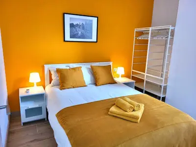 a plant sitting on top of a couch with a yellow pillow at NUEVO Apartamentos Costa del Alma in Valencia