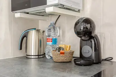 a kitchen counter with a coffee maker and a blender at NUEVO Apartamentos Costa del Alma in Valencia