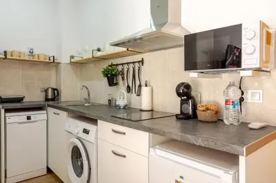 a kitchen with a sink and a washing machine at NUEVO Apartamentos Costa del Alma in Valencia