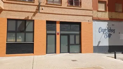 a brick building with two large glass doors on it at NUEVO Apartamentos Costa del Alma in Valencia