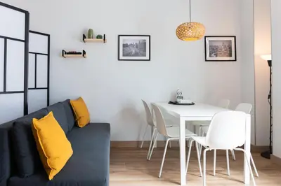 a kitchen with a white table and a white dining room at NUEVO Apartamentos Costa del Alma in Valencia