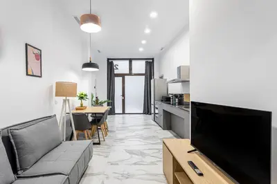 a living room with a couch and a flat screen tv at New Apartment 1 ROOM,4 pax,wifi, ACRuzafa market in Valencia