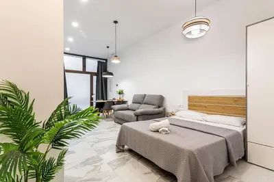 a bedroom with a bed and a couch and a chair at New Loft Ruzafa market, wifi AC in Valencia