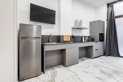 a kitchen with a stainless steel refrigerator and a counter at New Loft Ruzafa market, wifi AC in Valencia