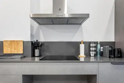 a kitchen with a sink and a stove top oven at New Loft Ruzafa market, wifi AC in Valencia