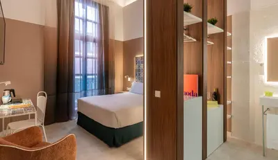 a hotel room with a bed and a desk at Axel Hotel Valencia - Adults Only in Valencia