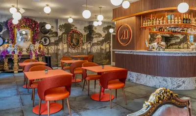 a restaurant with tables and chairs and a bar at Axel Hotel Valencia - Adults Only in Valencia