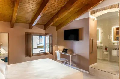 a bedroom with a bed and a desk and a window at Axel Hotel Valencia - Adults Only in Valencia