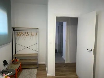 a white room with a mirror and a hallway at Junto al Jardín del Turia Apartamento in Valencia