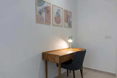 a desk with a chair and a lamp on a wall at VLC HOST - Alfaro A in Valencia