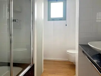 a bathroom with a shower and a toilet and a sink at Stylish well-connected beachfront flat in Valencia