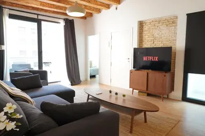 a balcony with couches and a table on a building at Apartamento Ático en Valencia in Valencia