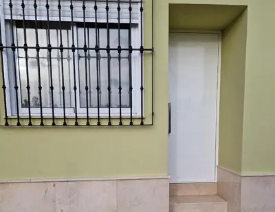 a door in a building with a window at Ca les Rinconetes in Riola