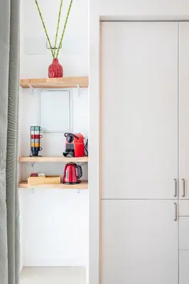 a kitchen with white cabinets and a white refrigerator at Julio's Apartment in Valencia